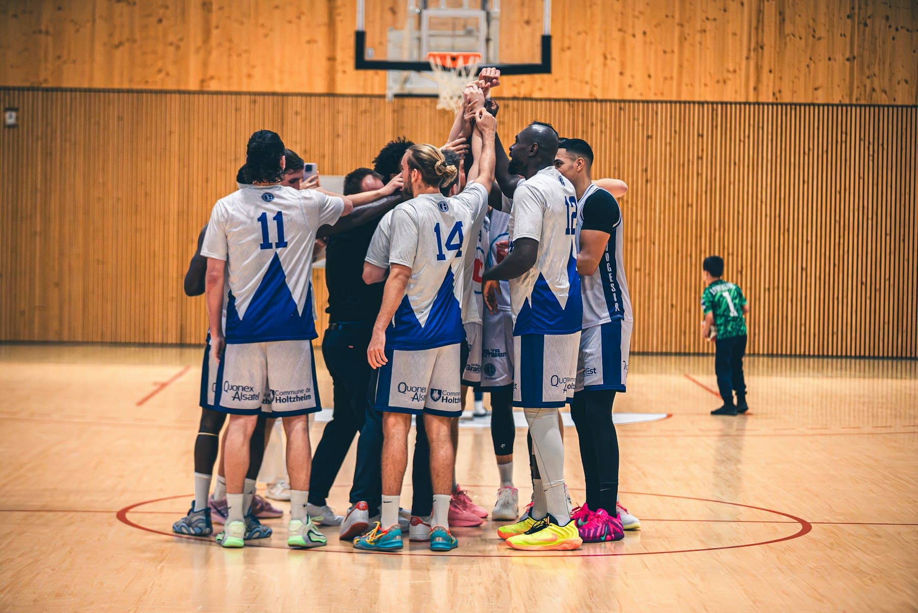 Basketball team huddle on an indoor court